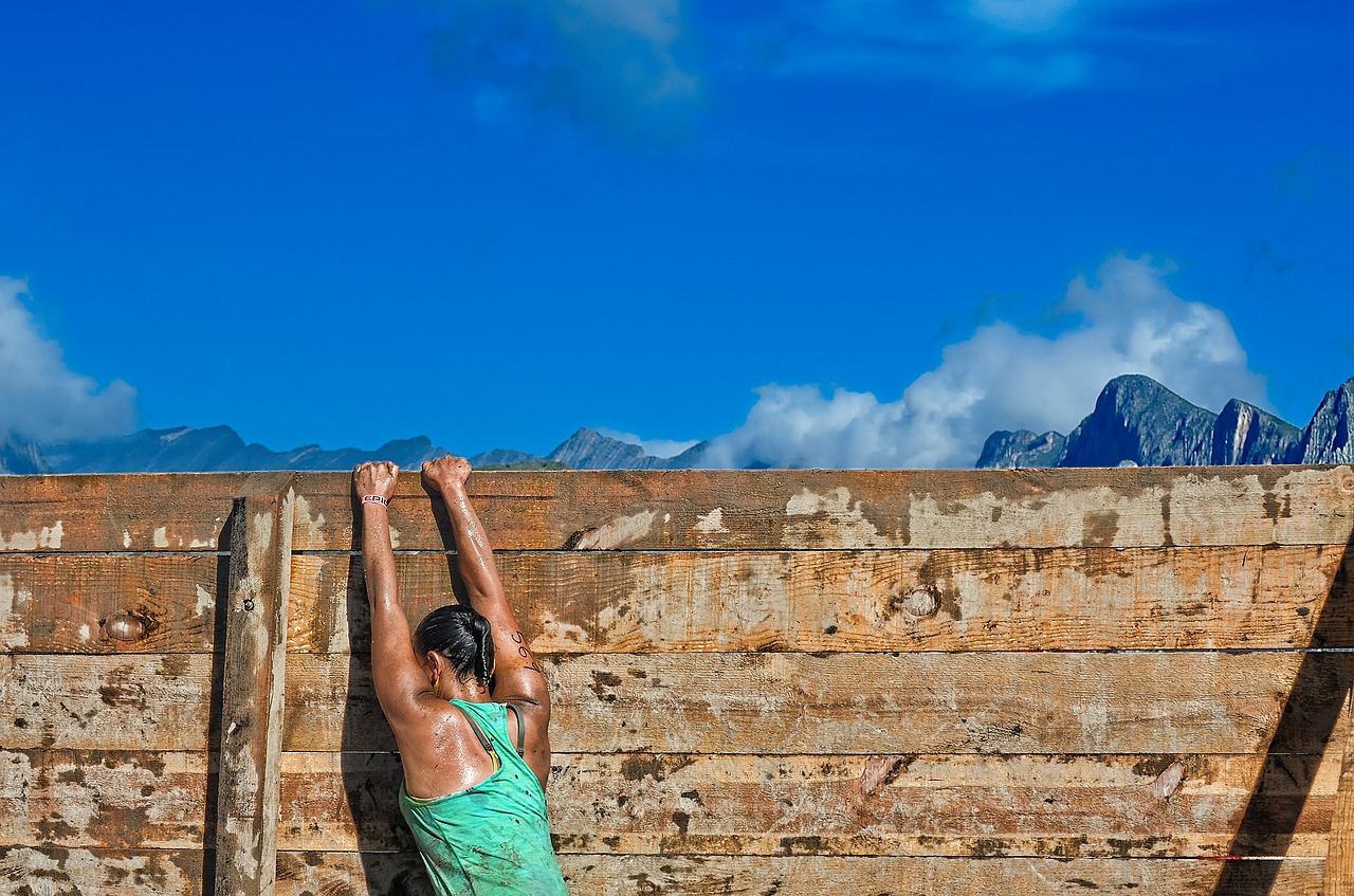 Rock climber hanging by fingers