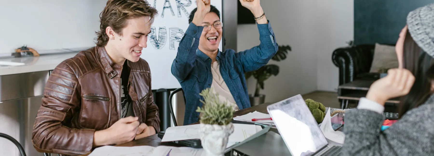 Colleagues in a meeting celebrating success